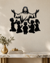 Silhouette of Jesus with arms outstretched above kneeling children, laser-cut in gloss piano black acrylic and float-mounted on a pale wall.