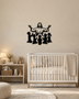 Silhouette of Jesus with arms outstretched above kneeling children, laser-cut in gloss piano black acrylic and float-mounted on a pale wall.