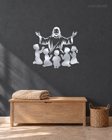 Silhouette of Jesus with arms outstretched above kneeling children, laser-cut in mirror silver acrylic and float-mounted on a pale wall.