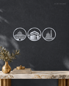 Three Holy Mosques Roundels — Acrylic Islamic Wall Art in mirror silver acrylic, float-mounted on a deep graphite wall
