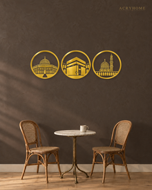 Three Holy Mosques Roundels — Acrylic Islamic Wall Art in mirror gold acrylic, float-mounted on a deep charcoal wall