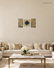 Three-piece art deco clock and panel set hung above a sofa in a living room, black chevron lattice over gold mirror.