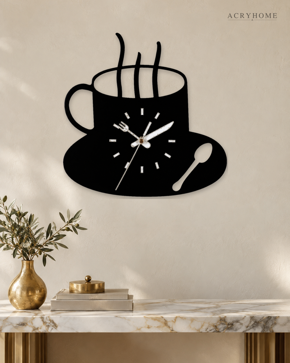 Coffee cup wall clock in black and white acrylic, the dial set into the cup, on a pale wall.