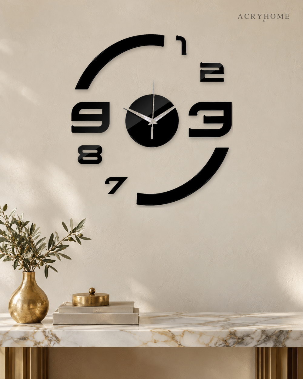 Floating numerals wall clock in black acrylic, oversized numbers and arcs with no dial, on a pale wall.