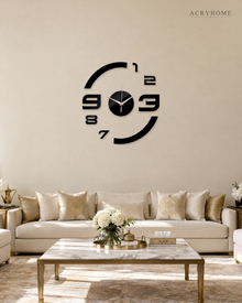 Black floating numerals wall clock on a living room wall, the numbers mounted straight to the plaster.