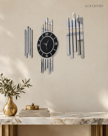 Vertical bar clock set of three in silver mirror and black acrylic, on a pale wall.