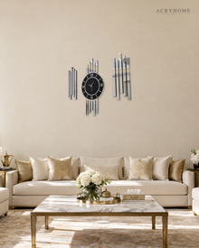 Silver mirror bar clock set hung above a sofa in a living room, staggered bars either side of a round clock.