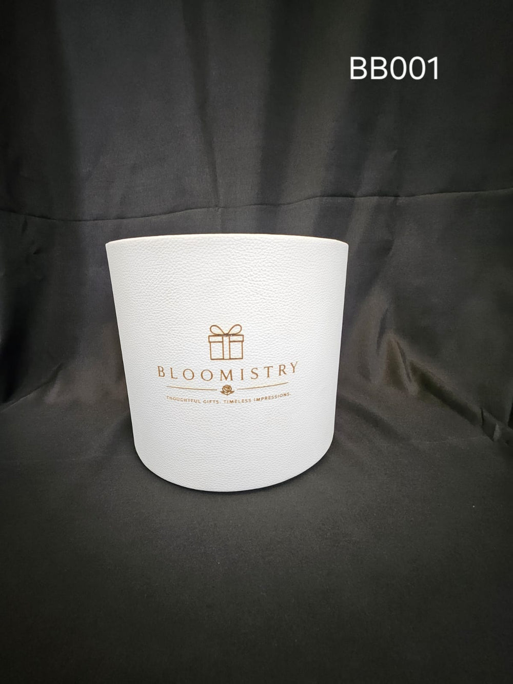 Deep round presentation box in white leatherette with gold Bloomistry mark