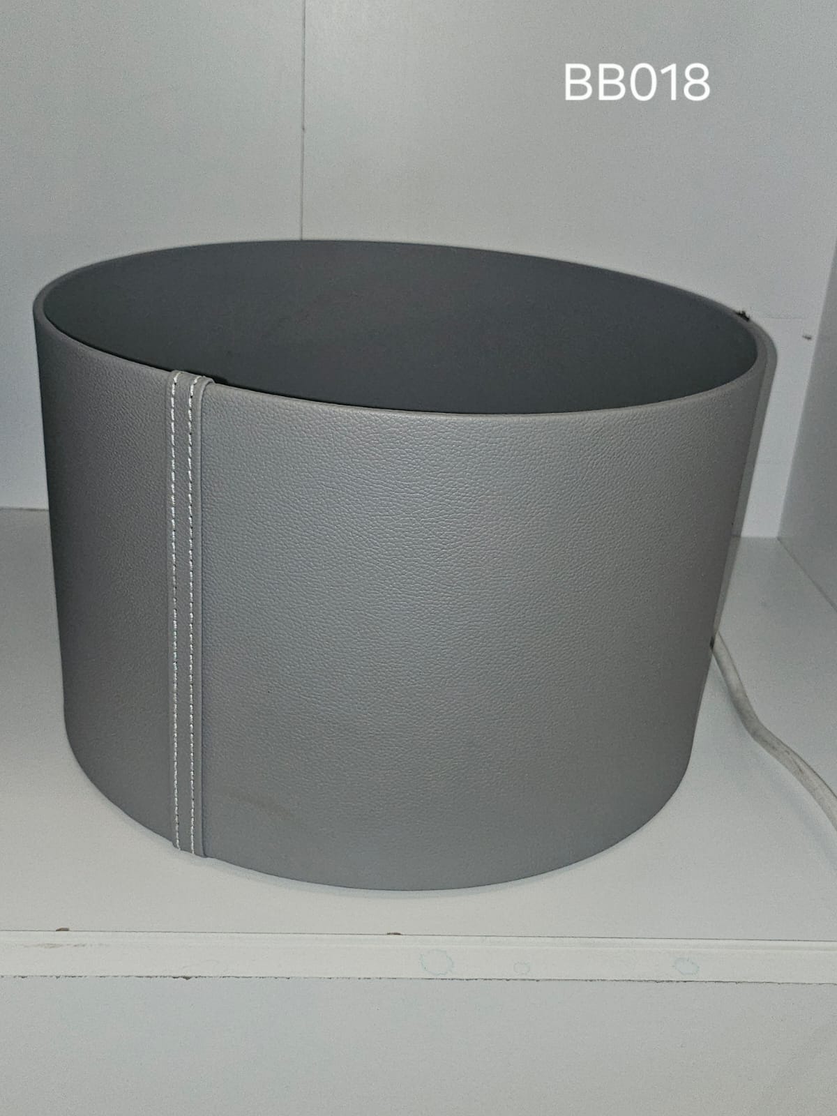 Deep oval box in grey with a stitched seam