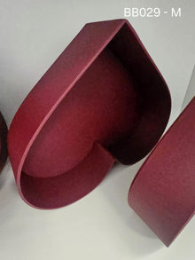 Red heart-shaped box with matching lid in a suede-like finish